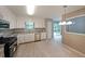 Bright kitchen features stainless steel appliances, granite countertops, ample cabinetry and backyard access at 5807 Christopher Ln, Lithonia, GA 30058