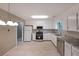 Bright kitchen with white cabinets, stainless steel appliances, and light-colored countertops at 5807 Christopher Ln, Lithonia, GA 30058