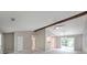 Open floor plan featuring exposed beam, modern lighting and views to the kitchen and backyard at 5807 Christopher Ln, Lithonia, GA 30058