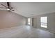Spacious living room with ceiling fan, neutral paint, and lots of natural light at 5807 Christopher Ln, Lithonia, GA 30058