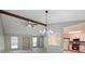 Open floor plan featuring exposed beam, modern lighting and views to the kitchen and backyard at 5807 Christopher Ln, Lithonia, GA 30058