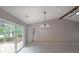 Open-concept living room with large windows, neutral paint and access to outdoor deck at 5807 Christopher Ln, Lithonia, GA 30058