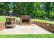 Outdoor brick fireplace area with a built-in grill, offering a cozy space for cooking and entertaining at 9701 Buice Rd, Alpharetta, GA 30022