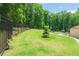 Spacious backyard featuring a well-maintained lawn, fountain, and patio area, perfect for outdoor entertaining at 9701 Buice Rd, Alpharetta, GA 30022