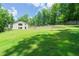 Vast backyard with a retaining wall and plenty of room for recreation and leisure at 9701 Buice Rd, Alpharetta, GA 30022