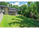 Expansive backyard with lush lawn, mature trees, and multi-level deck, perfect for outdoor living at 9701 Buice Rd, Alpharetta, GA 30022