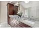 Bathroom with double granite vanity, modern fixtures, and ample cabinet space at 9701 Buice Rd, Alpharetta, GA 30022