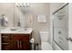 Bathroom featuring a vanity with a single sink, tile floor, and a shower with a glass door at 9701 Buice Rd, Alpharetta, GA 30022