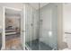 Bathroom featuring a glass-enclosed shower and tiled walls at 9701 Buice Rd, Alpharetta, GA 30022