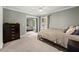 Bedroom with a neutral color scheme, ceiling fan, and mirrored closet doors at 9701 Buice Rd, Alpharetta, GA 30022