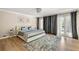 Bedroom featuring hardwood flooring, light gray walls and access to a balcony at 9701 Buice Rd, Alpharetta, GA 30022