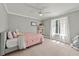 Bedroom featuring a light gray color scheme, ceiling fan, and natural lighting at 9701 Buice Rd, Alpharetta, GA 30022