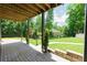 Inviting covered patio offering views of the serene, well-maintained backyard and lush greenery at 9701 Buice Rd, Alpharetta, GA 30022