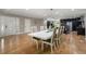 Bright dining area with modern lighting, a large table, and views of the kitchen at 9701 Buice Rd, Alpharetta, GA 30022