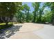 Spacious driveway surrounded by lush trees and plants, leading to a beautiful home at 9701 Buice Rd, Alpharetta, GA 30022