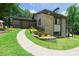 Charming home featuring a stone facade, manicured landscaping, and a welcoming walkway at 9701 Buice Rd, Alpharetta, GA 30022