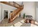 Bright foyer features wood staircase, neutral walls, tile floor, and abundant natural light at 9701 Buice Rd, Alpharetta, GA 30022