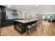 Open kitchen with large island, stainless appliances, and seamless flow into the dining and living areas at 9701 Buice Rd, Alpharetta, GA 30022