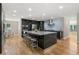 Modern kitchen featuring a large island, stainless steel appliances, and a breakfast bar at 9701 Buice Rd, Alpharetta, GA 30022