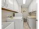 Laundry room with white cabinets, counter space, and modern appliances at 9701 Buice Rd, Alpharetta, GA 30022