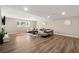 Spacious living room with recessed lighting, wood floor, a large window and comfortable seating at 9701 Buice Rd, Alpharetta, GA 30022