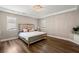 Beautiful bedroom with hardwood floors, a decorative ceiling, and abundant natural light at 9701 Buice Rd, Alpharetta, GA 30022