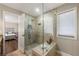 Modern shower with a glass enclosure, rain shower head, and built-in bench at 9701 Buice Rd, Alpharetta, GA 30022