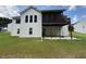 A view of the back of the home, including a screened-in porch and a spacious yard at 2504 Dalesford Ct, Dacula, GA 30019