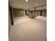 Large finished basement with carpet and multiple seating areas at 2504 Dalesford Ct, Dacula, GA 30019