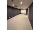 Finished basement with carpeting and projector screen for movie nights at 2504 Dalesford Ct, Dacula, GA 30019
