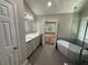 Bright bathroom boasts double vanity, soaking tub, tiled floors, and a glass-enclosed shower at 2504 Dalesford Ct, Dacula, GA 30019