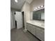 Bathroom featuring double sinks, a large mirror, and a walk-in shower at 2504 Dalesford Ct, Dacula, GA 30019