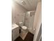Bathroom with a white toilet, shower and vanity with dark floor mats at 2504 Dalesford Ct, Dacula, GA 30019