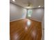 Well-lit bedroom with hardwood floors and a window offering natural light at 2504 Dalesford Ct, Dacula, GA 30019