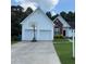 Traditional home featuring a two-car garage and a well-maintained front lawn at 2504 Dalesford Ct, Dacula, GA 30019
