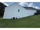 Home exterior showing the backyard lawn, siding, and air conditioning unit at 2504 Dalesford Ct, Dacula, GA 30019