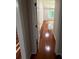Hallway with hardwood floors leading to a bright bedroom with a window at 2504 Dalesford Ct, Dacula, GA 30019