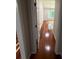 Hallway with hardwood floors leading to a bright bedroom with a window at 2504 Dalesford Ct, Dacula, GA 30019