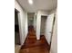 Hallway with hardwood floors and an open closet space at 2504 Dalesford Ct, Dacula, GA 30019