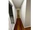 Hallway view highlighting hardwood floors and access to bedrooms and bathrooms at 2504 Dalesford Ct, Dacula, GA 30019