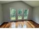 Bright living room filled with natural light from the large windows and hardwood floors at 2504 Dalesford Ct, Dacula, GA 30019