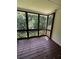 Enclosed screened porch with a wooded view and wooden flooring at 2504 Dalesford Ct, Dacula, GA 30019