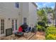 View of a backyard with patio, chairs, a grill and well-maintained landscaping at 2677 Sardis Chase Ct, Buford, GA 30519