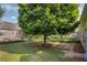 Backyard features a large tree, a well manicured lawn and landscaped garden beds at 2677 Sardis Chase Ct, Buford, GA 30519