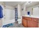 Bathroom boasts a tub with shower, vanity with sink, and colorful accents at 2677 Sardis Chase Ct, Buford, GA 30519