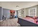 Bedroom featuring a gray accent wall and two windows, along with hardwood floors at 2677 Sardis Chase Ct, Buford, GA 30519