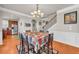 Dining room with hardwood floors, chandelier lighting, and seamless flow to the kitchen and staircase at 2677 Sardis Chase Ct, Buford, GA 30519