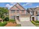 Charming two-story brick home with a well-maintained lawn, attached two car garage, and classic architectural details at 2677 Sardis Chase Ct, Buford, GA 30519