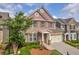 Charming brick two-story home with a covered entrance, two-car garage, and manicured landscaping at 2677 Sardis Chase Ct, Buford, GA 30519