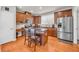 Well-lit kitchen features stainless steel appliances, wood cabinets, and a center island with seating at 2677 Sardis Chase Ct, Buford, GA 30519